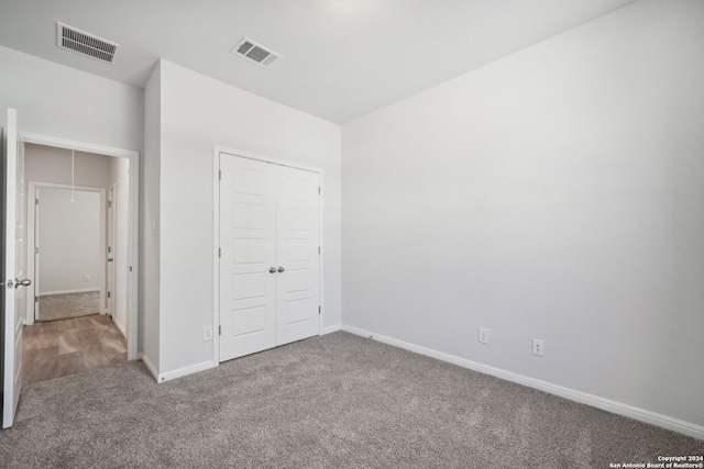 unfurnished bedroom with a closet and carpet floors