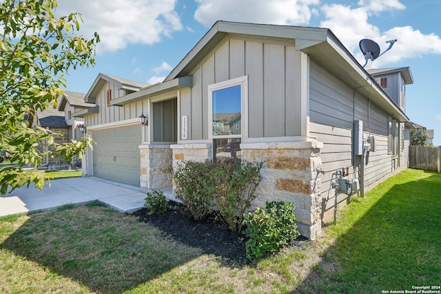 view of side of property featuring a yard and a garage