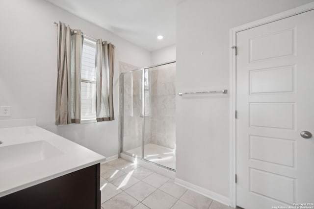 bathroom featuring vanity, tile patterned floors, and a shower with shower door