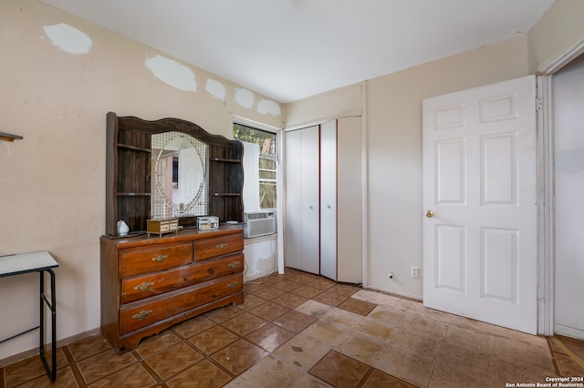 bedroom with a closet and cooling unit