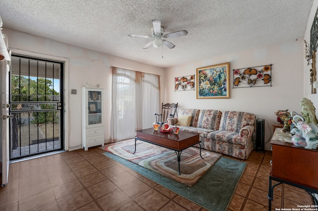 living room featuring a textured ceiling, a healthy amount of sunlight, and ceiling fan