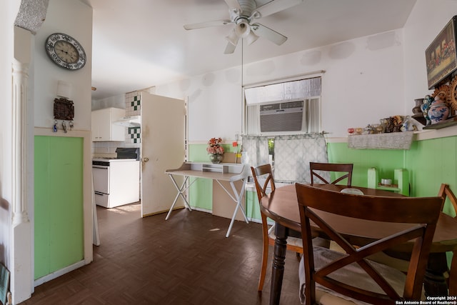 dining room featuring cooling unit, dark parquet flooring, and ceiling fan