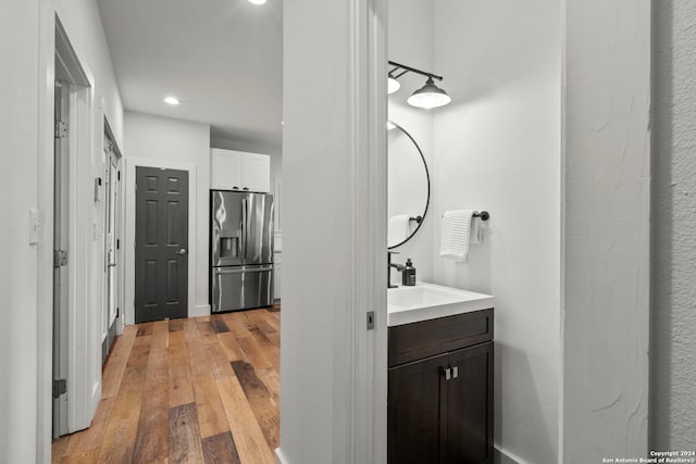 bathroom with hardwood / wood-style flooring and vanity