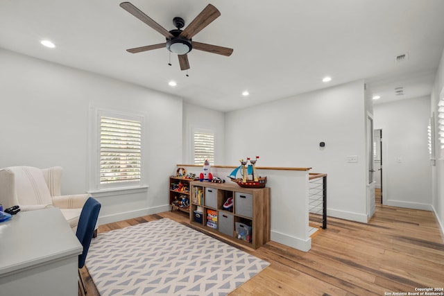 home office featuring light wood-type flooring and ceiling fan