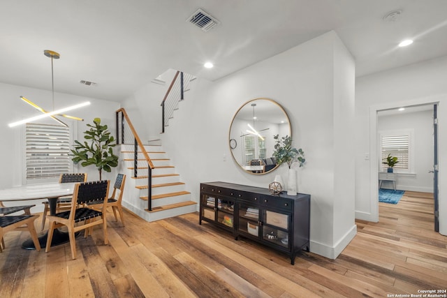 dining room featuring light wood-type flooring and a notable chandelier