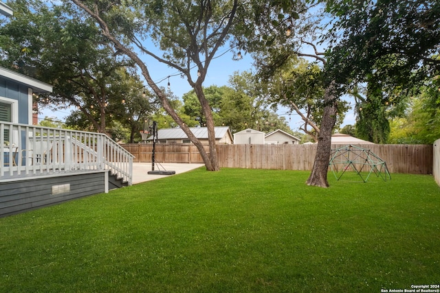 view of yard with a patio area and a wooden deck