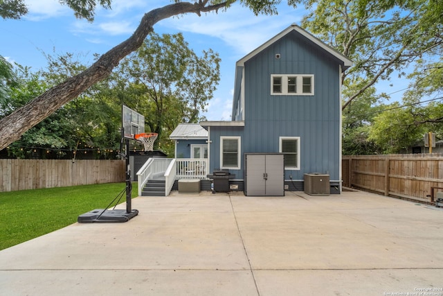 back of property featuring a patio, cooling unit, and a yard