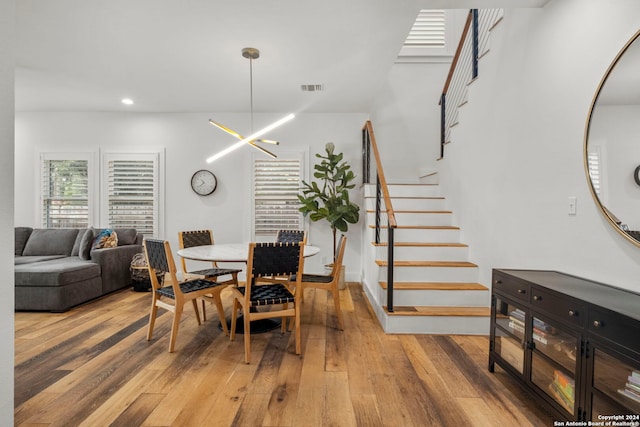 dining space featuring an inviting chandelier and wood-type flooring