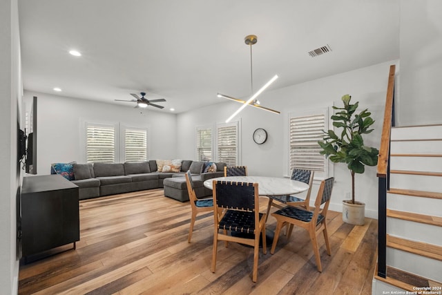 dining room with wood-type flooring and ceiling fan