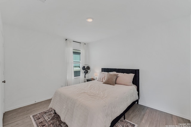 bedroom with hardwood / wood-style floors