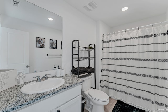 bathroom with vanity, toilet, wood-type flooring, and a shower with shower curtain