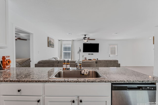 kitchen with white cabinetry, ceiling fan, stone counters, and stainless steel dishwasher