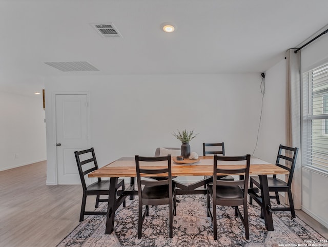 dining space with light hardwood / wood-style flooring