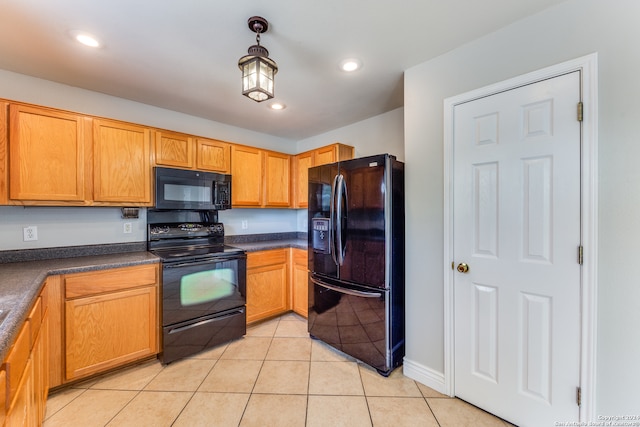 kitchen featuring black appliances, pendant lighting, and light tile patterned floors