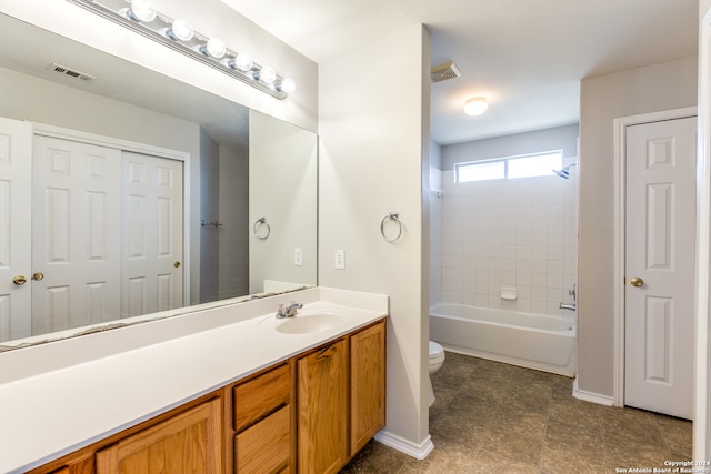 full bathroom featuring vanity, toilet, and tiled shower / bath combo