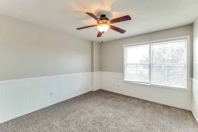 unfurnished room with carpet and ceiling fan