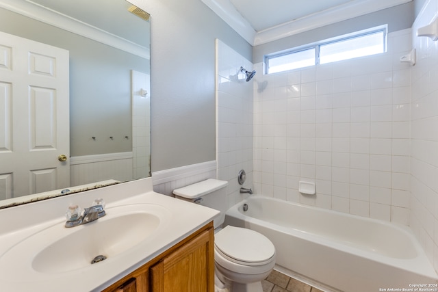 full bathroom featuring tiled shower / bath, vanity, crown molding, and toilet