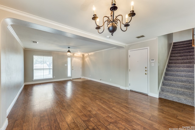 interior space featuring crown molding, dark hardwood / wood-style floors, and a chandelier