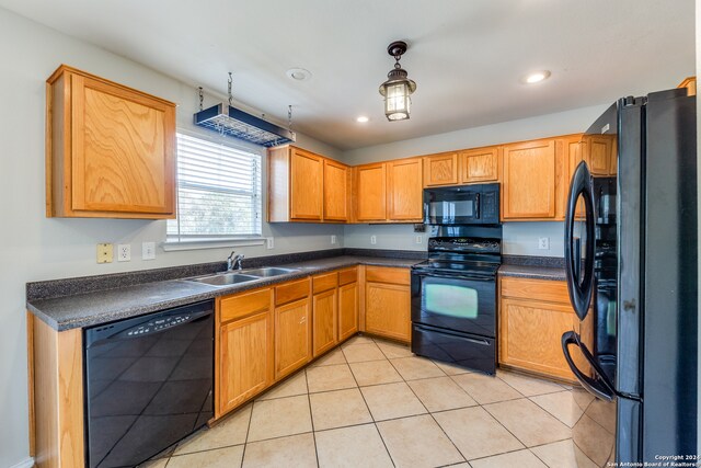 kitchen with sink, light tile patterned flooring, black appliances, and decorative light fixtures