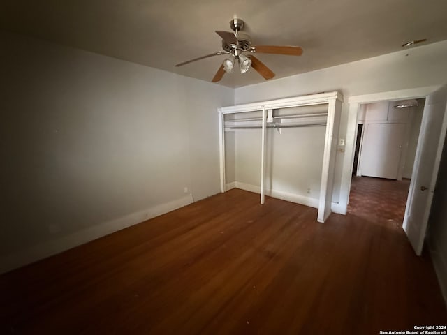 unfurnished bedroom featuring dark hardwood / wood-style floors and ceiling fan