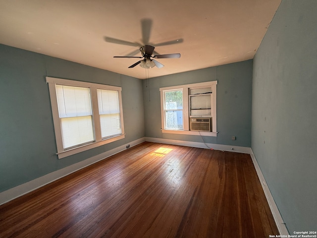 spare room with cooling unit, hardwood / wood-style flooring, and ceiling fan