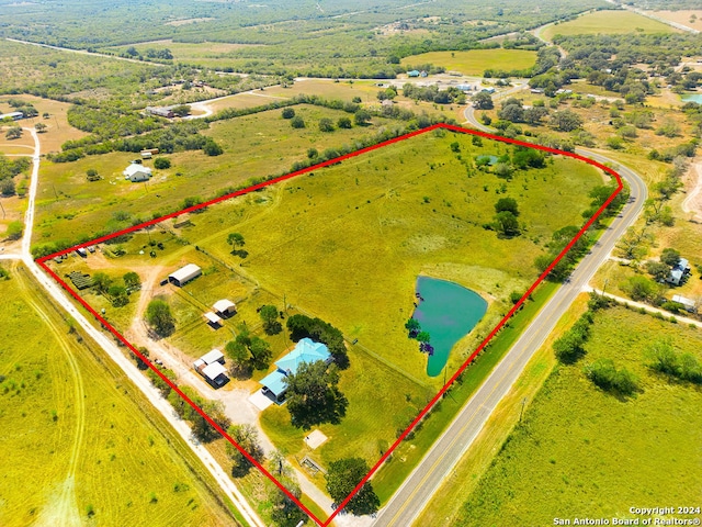 birds eye view of property featuring a water view and a rural view