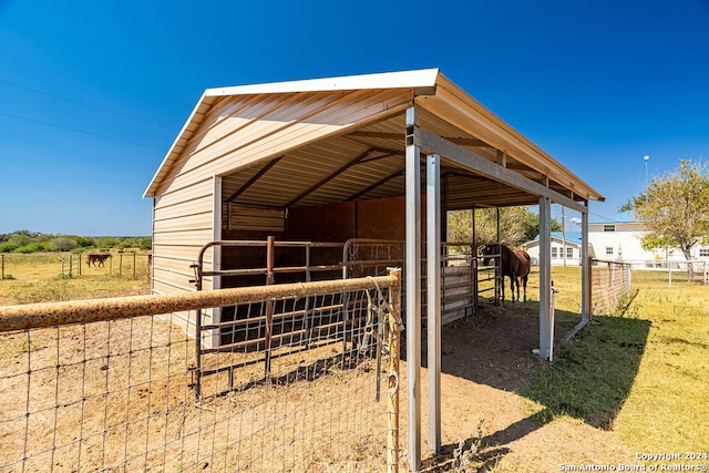 view of stable with a rural view