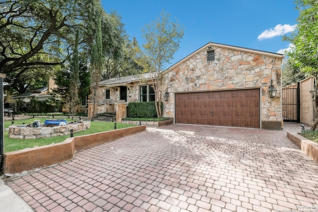 ranch-style house with a front yard and a garage