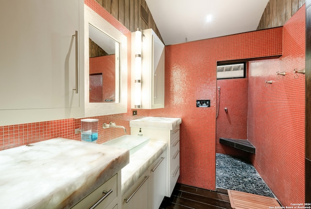 bathroom featuring vanity, wood-type flooring, and tile walls