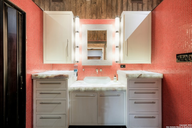 bathroom featuring vanity and tasteful backsplash