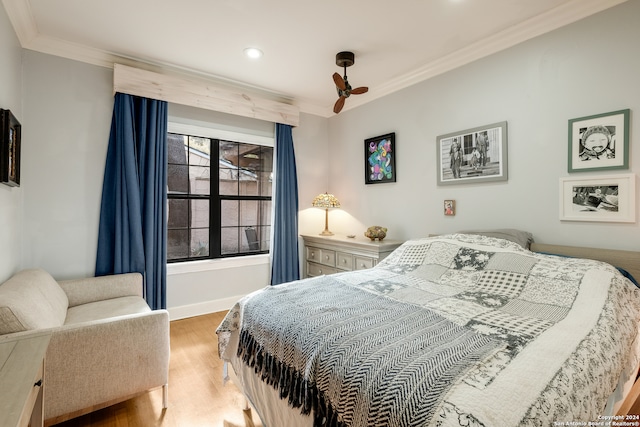 bedroom with ornamental molding and hardwood / wood-style floors