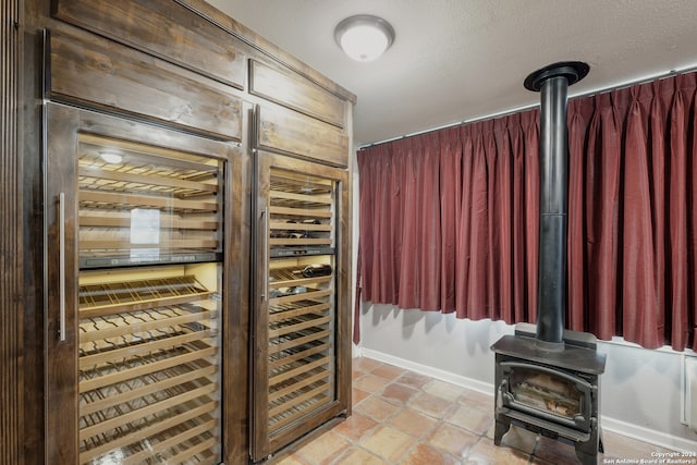 wine cellar with wine cooler and a wood stove