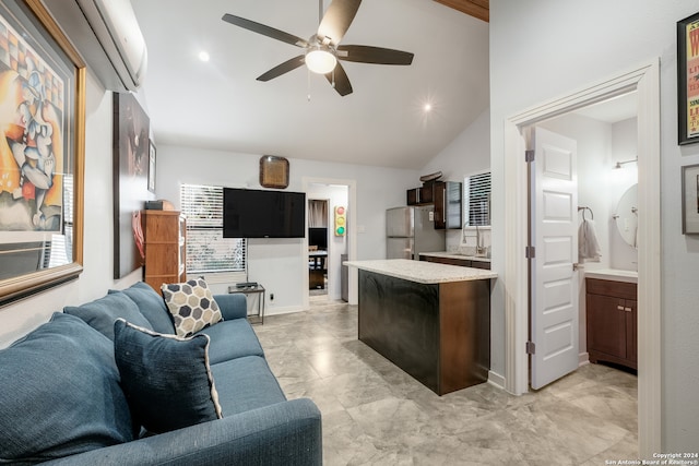 kitchen with ceiling fan, high vaulted ceiling, sink, and stainless steel fridge