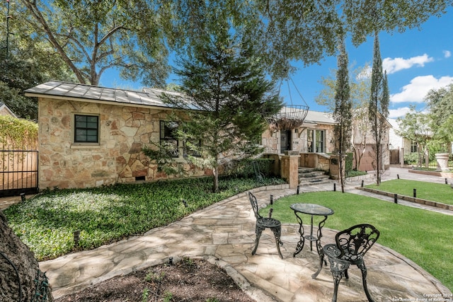 exterior space with a front lawn and a patio area