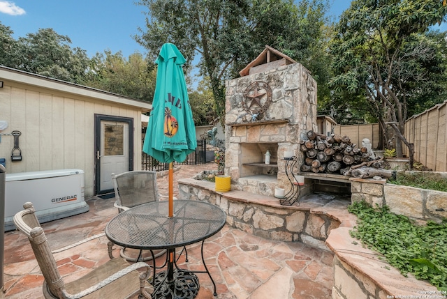 view of patio / terrace with an outdoor stone fireplace