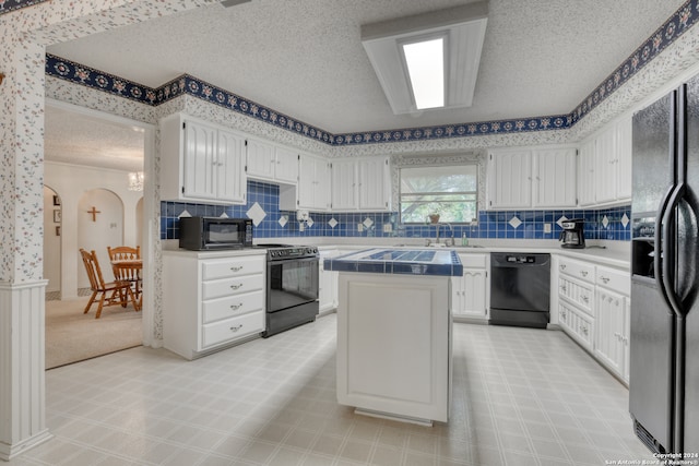 kitchen featuring black appliances, backsplash, a textured ceiling, a center island, and white cabinetry