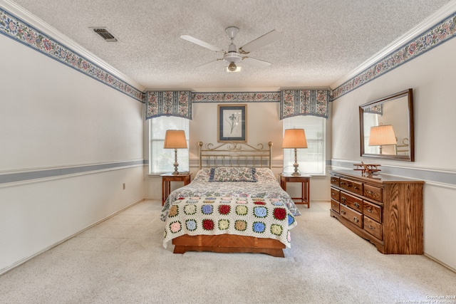 bedroom featuring ceiling fan, light carpet, and a textured ceiling