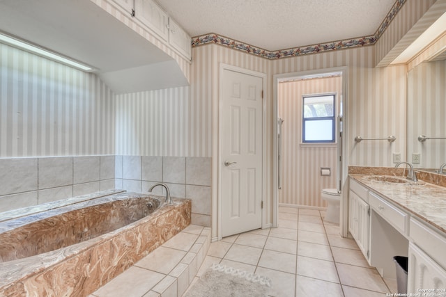 bathroom with a bath, a textured ceiling, toilet, tile patterned floors, and vanity