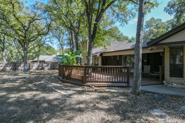 view of yard featuring a patio area and a deck