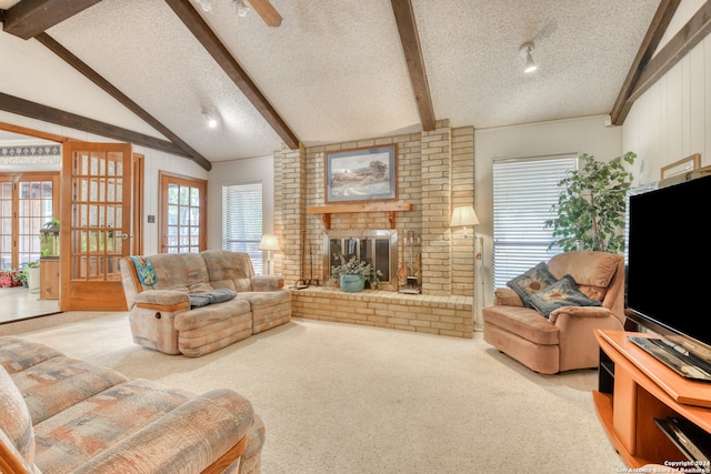 carpeted living room with vaulted ceiling with beams, a textured ceiling, a fireplace, and ceiling fan