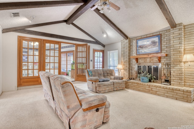 living room featuring vaulted ceiling with beams, light carpet, a textured ceiling, and a brick fireplace