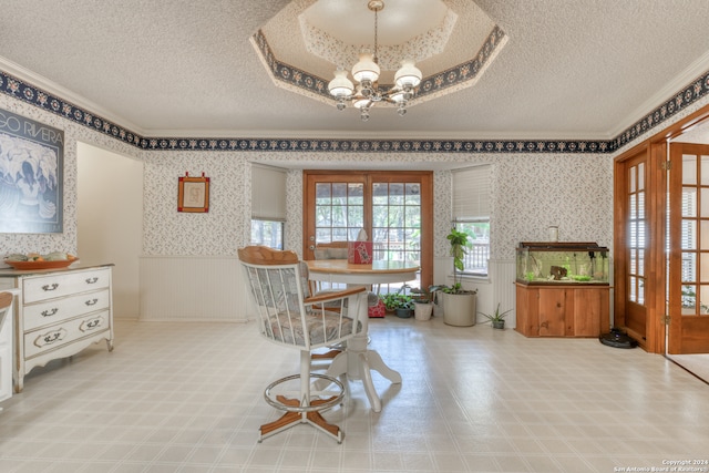 dining space featuring a textured ceiling and an inviting chandelier