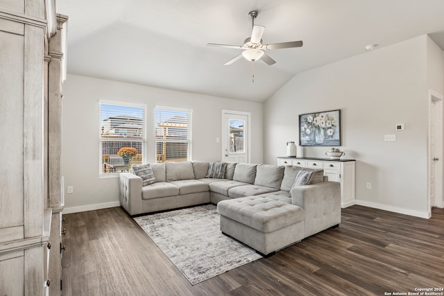 living room featuring dark hardwood / wood-style floors, ceiling fan, and vaulted ceiling