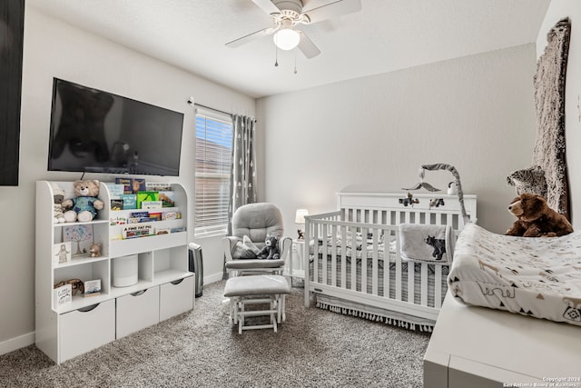 carpeted bedroom with a nursery area and ceiling fan