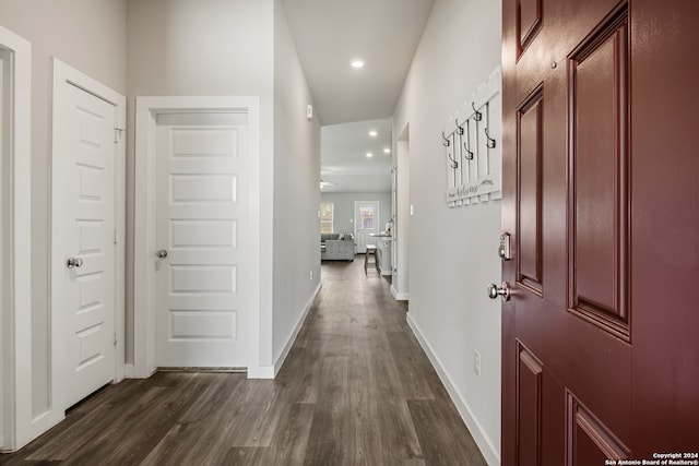 corridor with dark hardwood / wood-style flooring