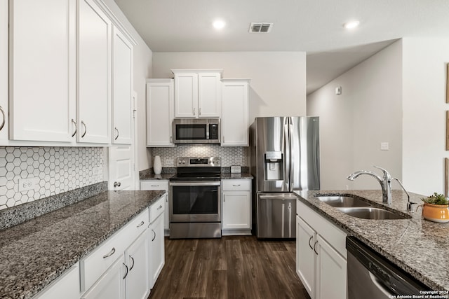 kitchen with white cabinetry, appliances with stainless steel finishes, sink, and dark hardwood / wood-style floors