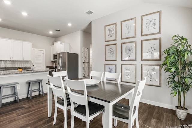 dining space with dark wood-type flooring and sink