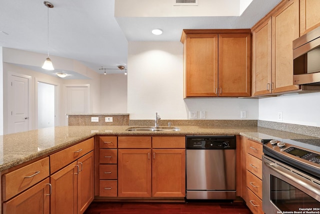 7342 Oak Manor Dr Unit 1204, San Antonio, TX 78229 - kitchen with stainless steel appliances, a sink, light stone countertops, dark wood-style floors, and a peninsula