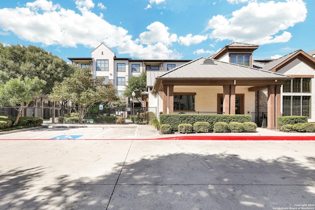 7342 Oak Manor Dr Unit 1204, San Antonio, TX 78229 - view of front of home with stucco siding, a standing seam roof, and metal roof