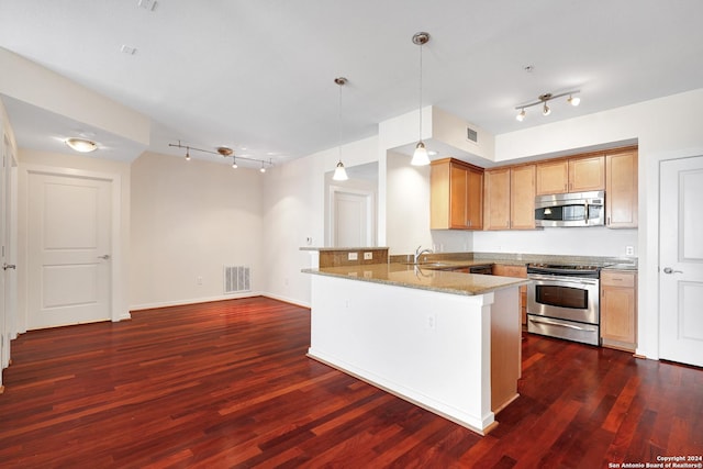 7342 Oak Manor Dr Unit 1204, San Antonio, TX 78229 - kitchen with stainless steel appliances, a peninsula, track lighting, a sink, and light stone countertops